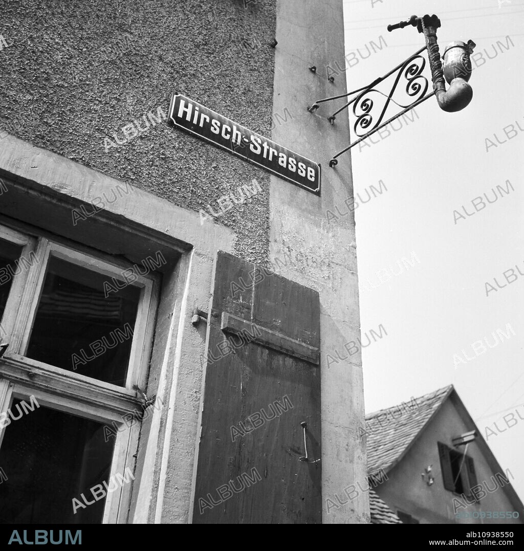 Sign of a tobacco and pipe shop at Crailsheim's Hirschstrasse street, Germany 1930s.