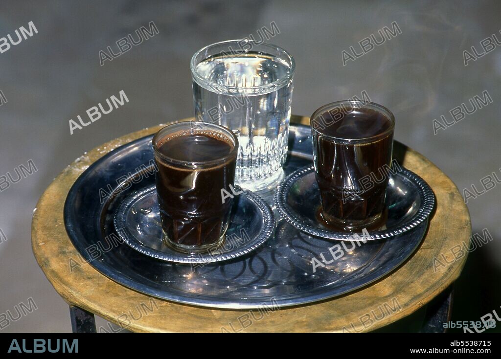 Four centuries ago coffee was all but unknown beyond the Horn of Africa and Southern Arabia, the area from which a small, berry-bearing tree, known to science as coffee arabica, first sprang. The unassuming plant which plays so important a part in our lives today, is thought to be indigenous to the Kaffa region of highland Ethipia -- from which the name 'coffee' may originate; others argue that it derives from its Arabic name qahwa. Certainly the earliest known legend concerning coffee -- still recounted today in the suqs, or markets, of Southern Arabia -- tells how an Arab goatherd called Kaldi, whilst out tending his flock, noted their queer behaviour on eating certain small berries. Kaldi tried them himself, liked the mild sense of euphoria they induced, and told his companions. Within a short time -- probably in the early 15th century -- the wild coffee plant had been introduced to the highlands of Yemen, and was being cultivated and selectively bred in a process which would eventually create the many diverse types of bean now available. Blue Mountain from Jamaica, Kenyan from East Africa, Java from Indonesia, Brasilica from Brazil -- all these famous blends derive originally from Kaldi's stunted shrubs, but the godfather of them all is Mocha.