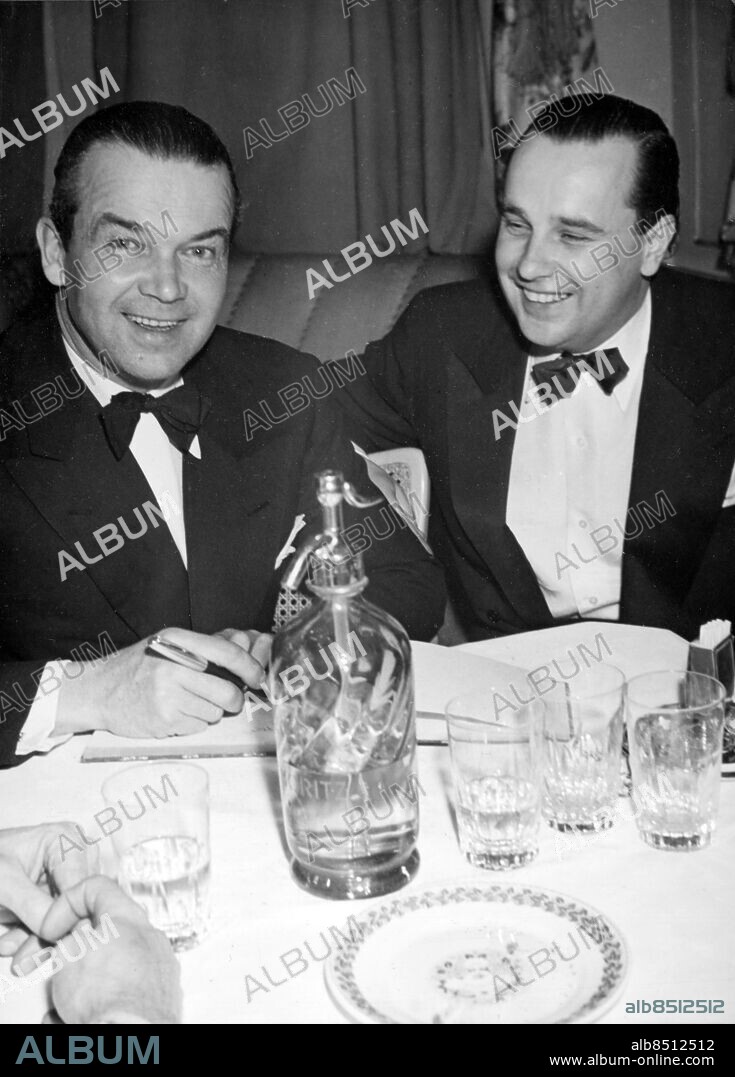 SCHWEIZ SANKT MORITZ 1948-01.. Orig. bildtext... RUDOLF CARACCIOLA I ST. MORITZ. Två racerbilexperter träffades på söndagskvällen på Palace Bar i St. Moritz: Rudolf Caracciola.v./ och direktör Henken Widengren. Anm. Fest i anslutning till de Olympiska Spelen Sifoner Fluga CD355 persons: RUDOLF CARACCIOLA;HENKEN WIDENGREN sites: TYSKLAND*;SVERIGE*;SCHWEIZ;SANKT MORITZ.