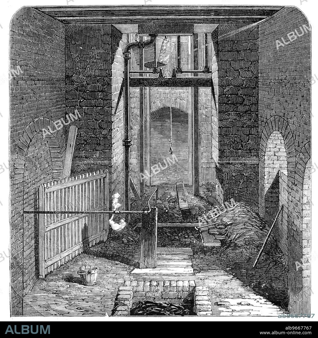 The Lund Hill Colliery Explosion: Mouth of the Downcast Shaft, 1857. Preparations to recover bodies after mining disaster in Barnsley. 'The Illustration represents the entrance to the downcast shaft, after the mouth had been closed. The iron basket in which the miners made their descent is suspended immediately over it, and a jet of steam is being forced through a pipe connected with the boiler into the pit, for the purpose of extinguishing the fire. The brick tank in the foreground of the sketch was filled with charcoal, preparatory to making carbonic acid gas, for the same purpose; but these means being considered inadequate, the water from a neighbouring stream is now being turned into the pit. Some days will elapse before it can be pumped out and any of the bodies be recovered'. From "Illustrated London News", 1857.