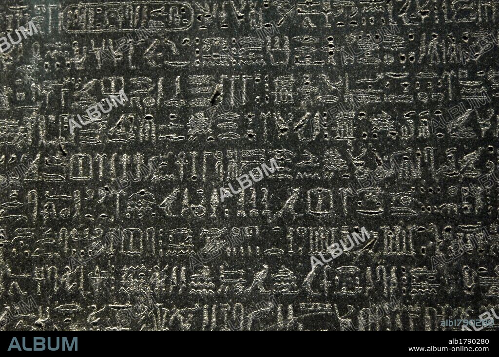 The Rosetta Stone. Fragment of a black granite stele with an inscription in different languages __of a decree of Ptolemy V Epiphanes king. Ptolemaic era. 196 BC. Detail. Hieroglyphical scripture. British Museum. London. United Kingdom.