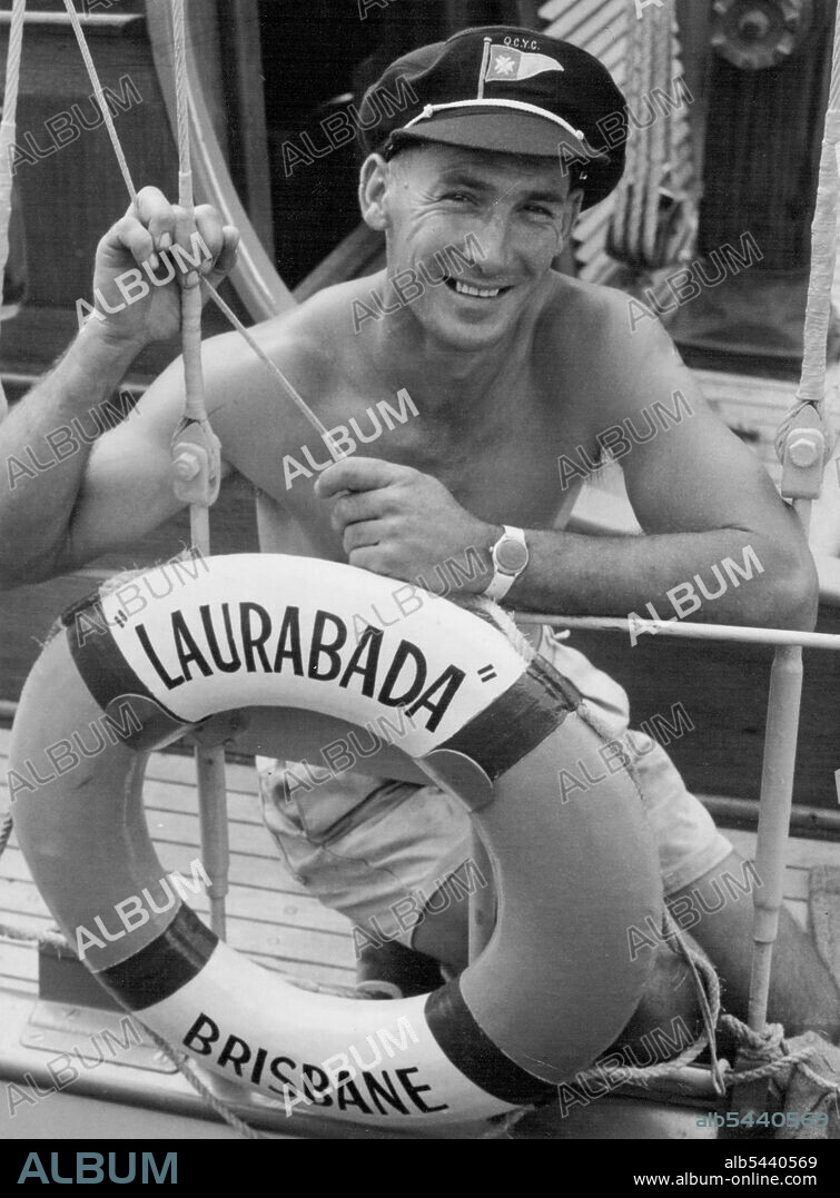 Tanned Ivan Holm, of Brisbane, leans over the railing of his yacht, Laurabada, before sailing to Sydney last week. He is the skipper of the only Queensland entry in the Sydney-Hobart yacht race. Holm designed and built the yacht himself. December 20, 1954. (Photo by The Telegraph Newspaper Co. Ltd.).