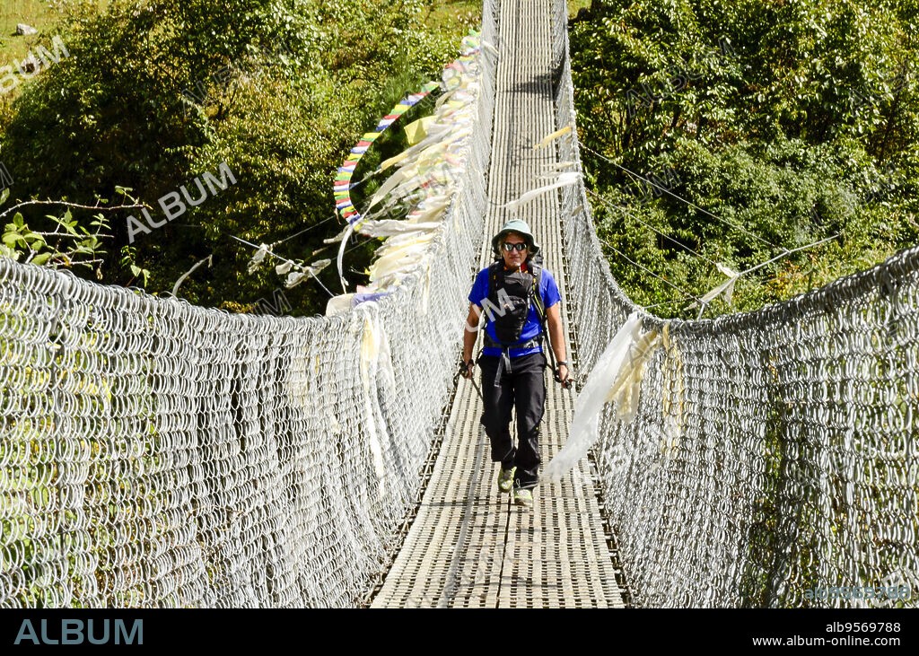 Hikers on the suspension bridge, Sagarmatha National Park, Khumbu Himal, Nepal, Asia.