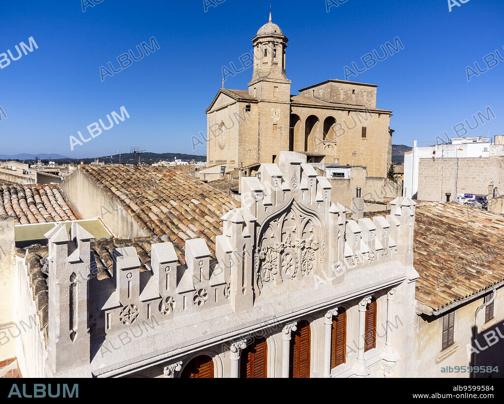 La Caixa façade, built in 1908, in neo-Gothic style, by Miquel Salvà, and parish church, LLucmajor, Mallorca, Balearic Islands, Spain.
