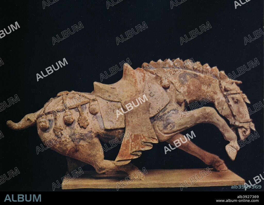 'Pottery Figure of a Horse - T'Ang Dynasty',  c7th to 10th century AD, (1936). The Tang dynasty was preceded by the Sui dynasty and followed by the Five Dynasties and Ten Kingdoms period. The photograph was taken for the International Exhibition of Chinese Art at the Royal Academy, Burlington House, London. The piece is part of the Eumorfopoulos Collection, British Museum, London. From The Connoisseur, Vol. 97, edited by H. Granville Fell. [International Studio, London, 1936].