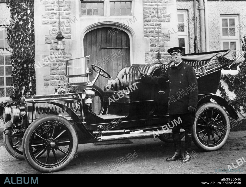 1908 De Dion Bouton model. Sir Walter Napien's chauffeur, James Glayshen, stands proudly by his convertible car.
