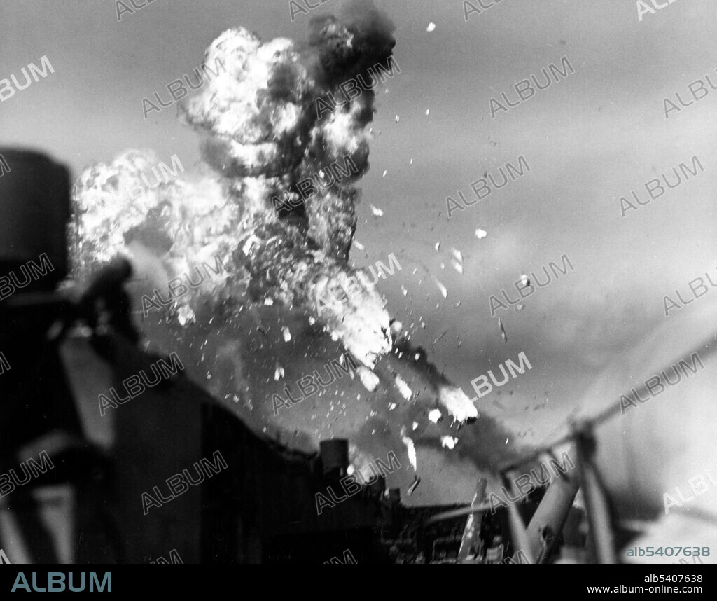 Japanese kamikaze plane disintegrates in flames after hitting USS Intrepid (CV-11), during operations off the Philippines on November 25, 1944. Kamikaze were a part of the Japanese Special Attack Units of military aviators who initiated suicide attacks for the Empire of Japan against Allied naval vessels in the closing stages of the Pacific campaign of WWII, designed to destroy warships more effectively than possible with conventional air attacks. About 3,800 kamikaze pilots died during the war, and more than 7,000 naval personnel were killed by kamikaze attacks. Kamikaze aircraft were essentially pilot-guided explosive missiles. (cropped and cleaned).