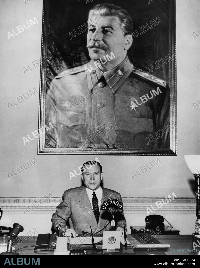 Orig. bildtext... MR. MALIK GOES ON THE RECORD New York. With a huge portrait of Premier Stalin watching him like Big Brother, Jacob Malik, Soviet Deputy Foreign Minister and the Kremlin's mouthpiece in the United Nations, is shown at the recording microphone in the Russian Delegation offices today, June 23, as he recorded his address in the Price of Peace series. This series of talks is produced by the United Nations Radio and carried in the U.S. by the Columbia Broadcasting System. In his address Malik declared that the Korean war can be settled peacefully and urged discussions between the warring sides for a cease fire and withdrawal of all forces from the 38th parallel. Malik failed to say, however, whether or not he planned to present these proposals through diplomatic channels or to the United Nations as a formal peace suggestion. 6.23.51 Not.Initiativtagaren till Koreafred (in spe) 23 juni 1951 Anm. J Malik, 1906-1980, sovjetisk diplomat och politiker, vice utrikesminister 1946 och 1960, FN-ambassadör 1948-1952 och 1968-1972. Tal Talare CD655 persons: JOSEF STALIN*;JACOB MALIK sites: NEW YORK;USA;SOVJETUNIONEN*.