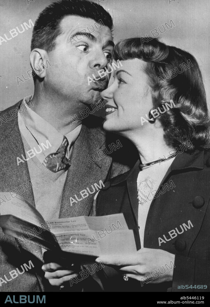 Ken Murray to Wed -- Comedian Ken Murray of stage, screen and radio plants a kiss on his bride-to-be, Actress Betty Lou Walters, 21, as they pick up a marriage license here yesterday. They plan to be married Dec. 1 at Riverside, Calif. *****. December 22, 1948. (Photo by Associated Press Wirephoto).