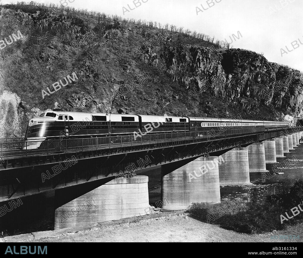 Harpers Ferry, West Virginia: c. 1951 The Baltimore and Ohio Railroad's Capitol Limited passenger train crossing the Potomac River on a trestle at Harpers Ferry.