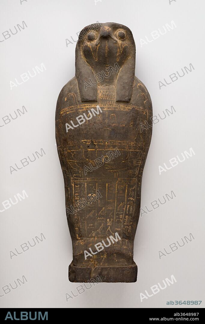 Coffin and corn mummy with Osiris mask. Dimensions: L. 49.2 cm (19 3/8 in.); W. 19.9 cm (7 13/16 in.). Date: 400-200 BC.
These falcon-headed coffins do not contain actual mummies but symbolic Osiris mummies stuffed with grain and sand. The falcon head on the coffins and the hieroglyphic text on the painted lid indicate they are associated with the funerary deity Ptah-Sokar-Osiris.
Such coffins and 'mummies' were prepared and buried in annual rites at certain centers as part of the mysteries of Osiris. Subsequent germination of the grain would symbolize the possibility of new life offered by Osiris.
Both this specimen and acc. no. 58.106a-d belong to a typological group, although this group cannot at this time be associated with any particular site.