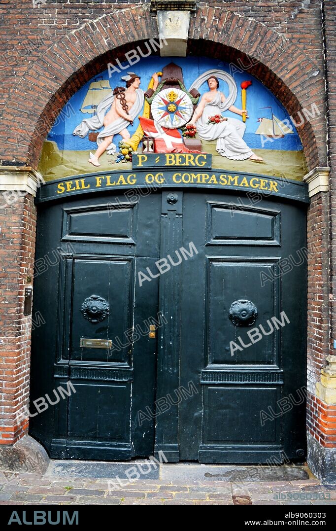 Old sign for a flag and compass maker 'Seil Flag og Compasmager' in Copenhagen's Nyhaven area, Denmark.