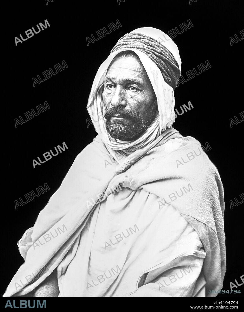 Black and white image of an Arab man against a black background; Algiers, Algeria.