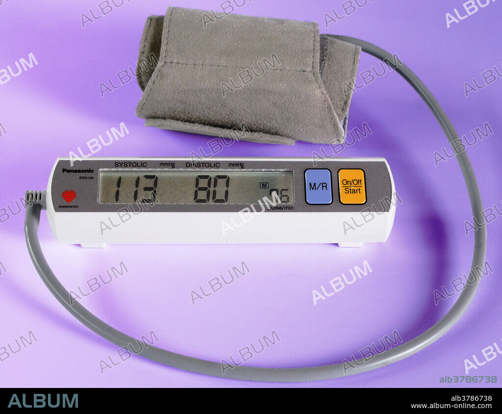 Editorial use only . Automatic portable blood pressure monitor (sphygmomanometer). This device is used to measure a person's blood pressure, an important indicator of health. Blood pressure numbers include systolic and diastolic pressures. Systolic blood pressure is the pressure when the heart beats while pumping blood. Diastolic blood pressure is the pressure when the heart is at rest between beats. Here, the monitor shows a reading of 113/80, which falls in the normal range.