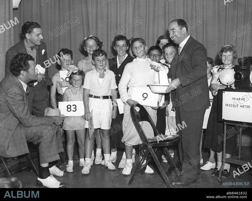 USA PHILADELPHIA 1930-tal.. Russell Patterson (tv), amerikansk illustratör, Jay C. Flippen (sittande), amerikansk skådespelare, och Lazy Dan, amerikansk radiounderhållare, är domare i en fräknetävling. Lazy Dan tvättar deltagarnas ansikten med tvål och vatten för att kunna se att fräknarna inte målats på.. Foto: Underwood & Underwood / AB Text & Bilder / SVT / Kod: 5600. Engelsk originalbildtext.. Mapp: Sportkuriosa Diverse Utan årtal O.B.S. 1930 talet 3562D. Fräknar.