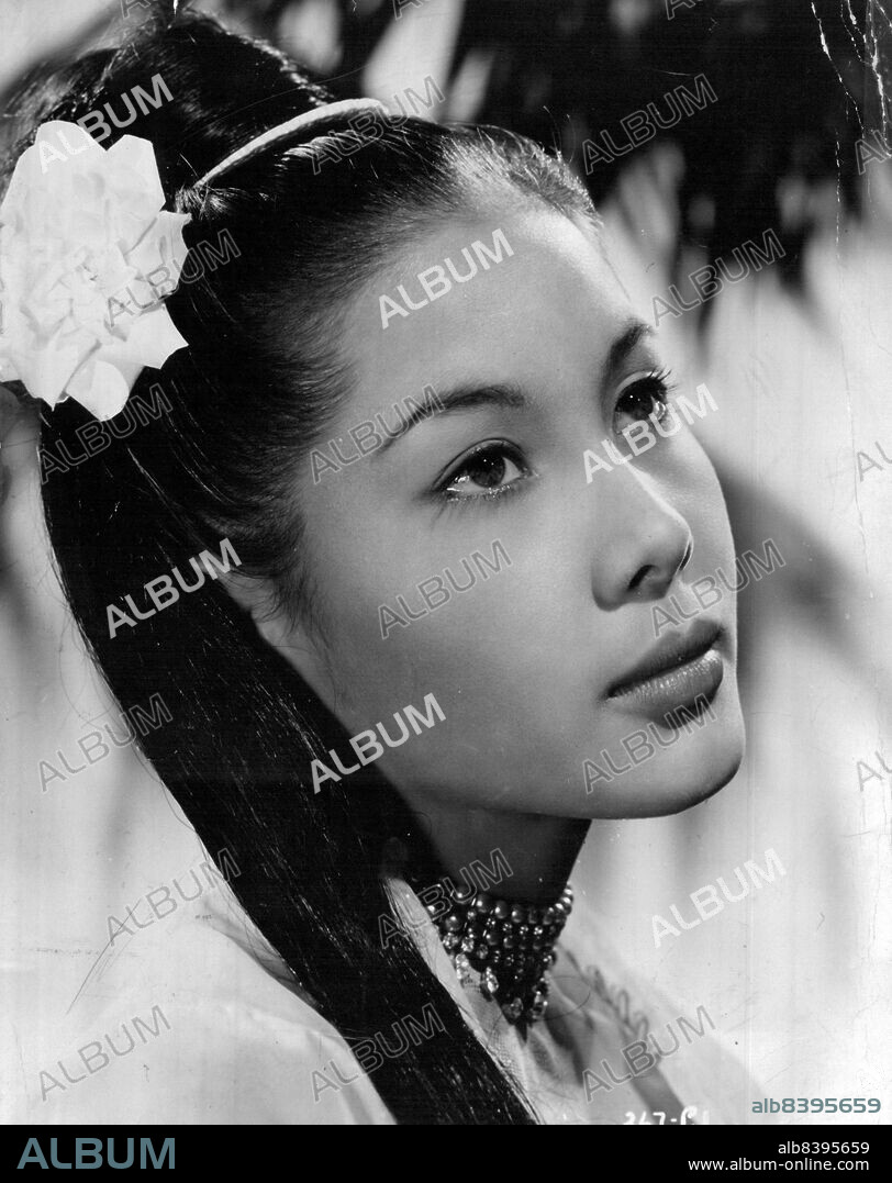 A kiss from actor Gregory Peck 10 years ago is part of the torment of a beautiful Eurasian film star who now sells fried gourds in a Rangoon market. 
Abandoning the fame and glitter of a film career, she entered a Buddhist convent in her search for "peace and tranquilty."
The actress - Win Min Than - rose to stardom opposite Peck in "The Purple Plain," a film about wartime Burma. August 6, 1954. (Photo by J. Arthur Rank Organisation Ltd.).