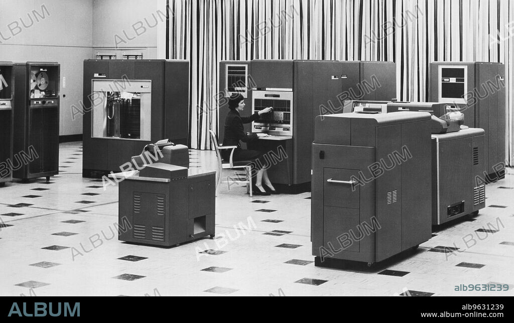 New York, New York, 1954 Woman using a new IBM 650 Magnetic Drum Data Processing Machine in the office. She's working at the ""electronic brain"" while the IBM RAM unit at left has a 6,000,000 digit memory.