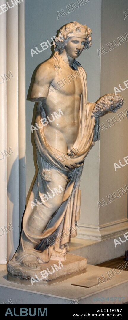 Marble sculpture of Dionysus, god of wine, shown holding a bunch of grapes. Roman, 2nd century AD. Found in the Temple of Dionysus at Cyrene (Libya). (Photo by: Universal History Archive/UIG via Getty Images).
