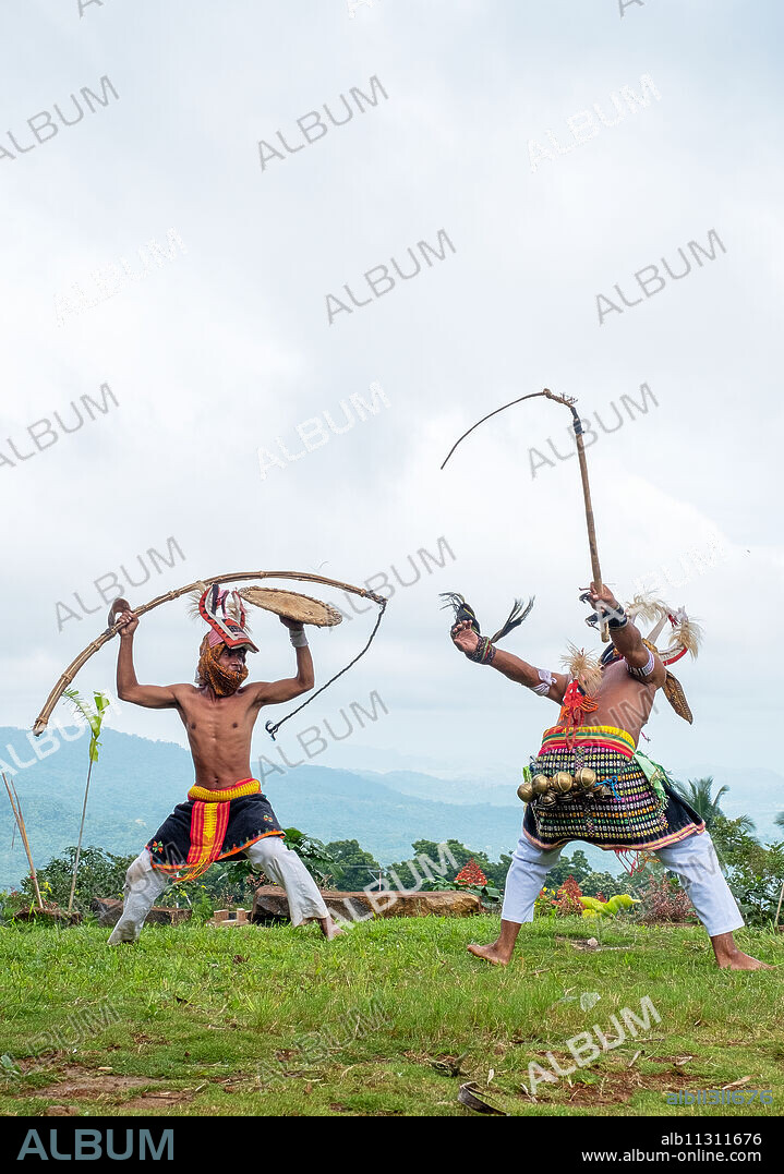 Caci men perform a traditional whip dance with bamboo shields and leather whips, western Flores, Indonesia, Southeast Asia, Asia.