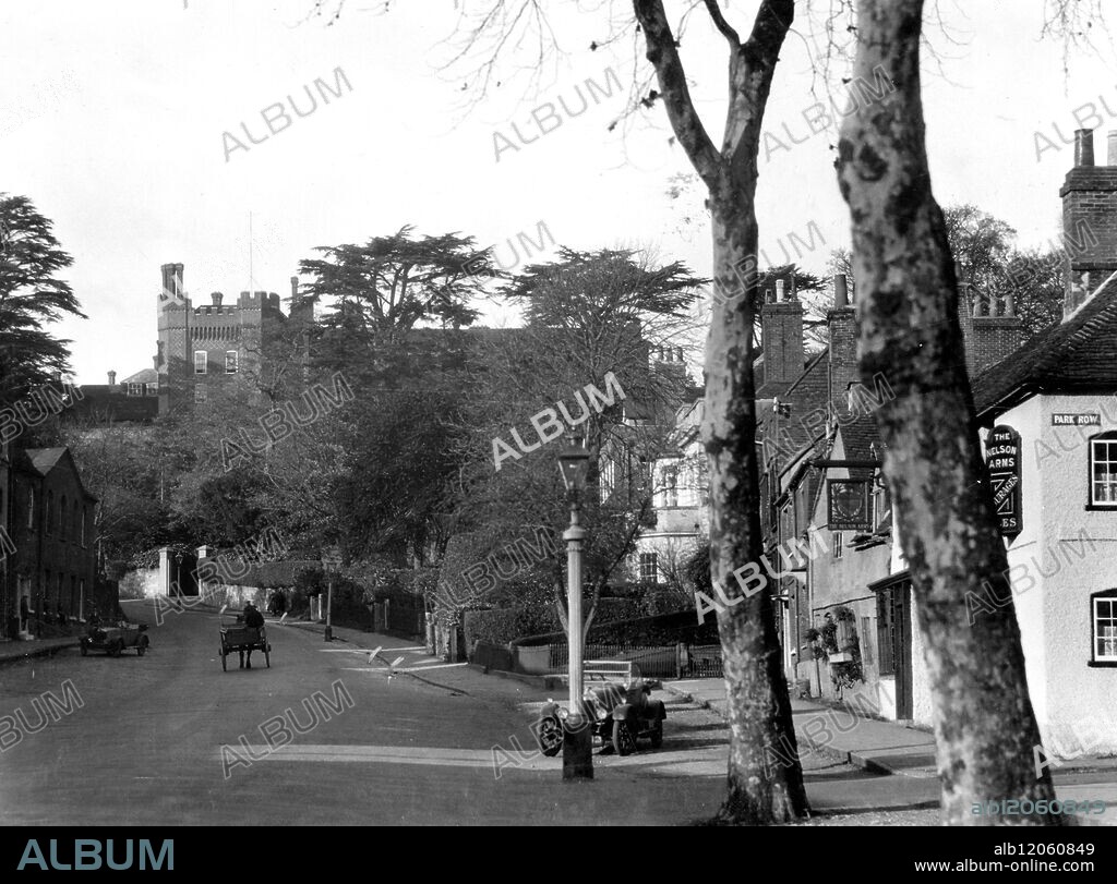 With a view of the Episcopal residence of the Bishop of Guildford , rising alongside the ancient Castle Keep , on the hill which overlooks the town , Castle Street , Farnham , Surrey , England . 19 November 1930.