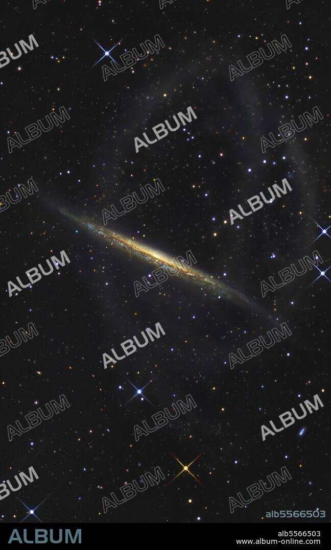 The Splinter Galaxy (NGC 5907), located in the constellation Draco, is viewed edge on from our perspective of 39 million light years away, features looping structures that represent the orbit of a former satellite galaxy that finally became aborbed.