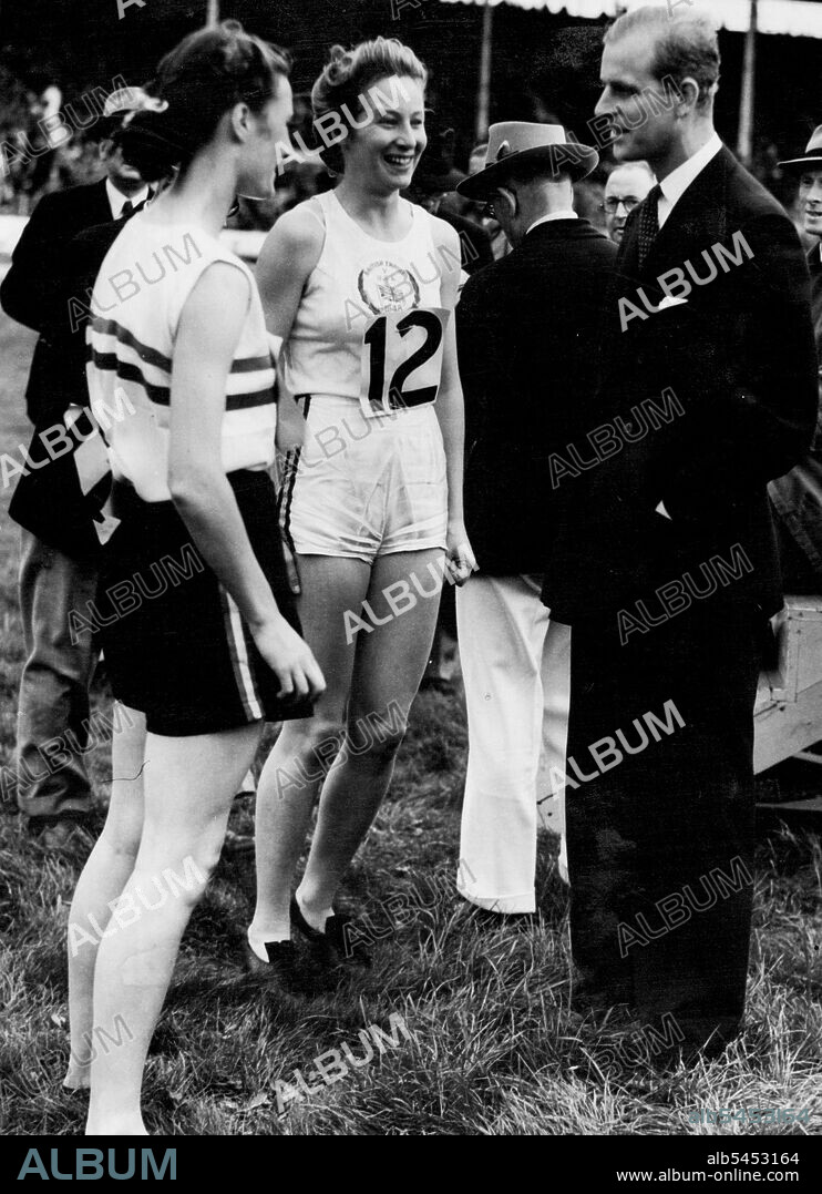 Australian Girls Wins 80 Metres Hurdles In British Empire Athletics Match Against United States -- The Duke of Edinburgh talking to Miss Maureen Gardner (Great Britain) who was second, and Miss S. Strickland (centre) the Australian girl, who was first, after the finish of the Women's 80 metres hurdles race, during the British Empire versus the United States Athletics match, which followed the Olympic Games, at the White City Stadium, London. August 12, 1948.