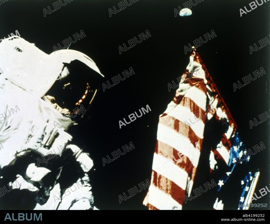 Astronaut Harrison Schmitt with US flag on the surface of the Moon, Apollo 17 mission, December 1972. Earth can be seen floating above the flag. US astronauts Eugene Cernan and Harrison Schmitt took samples from the lunar surface. Apollo 17 was the last Apollo Moon landing mission.