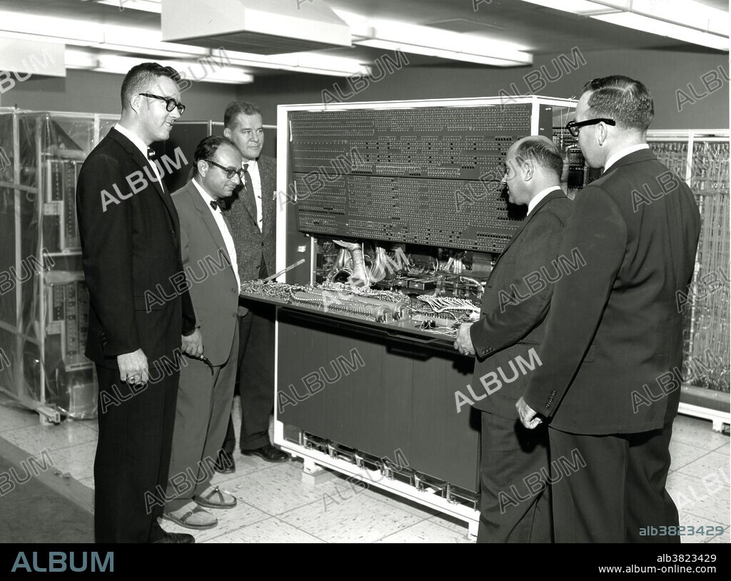 Lawrence Livermore National Laboratory staff, Clarence Badger, Sid Fernbach, and Richard von Holdt inspect the wiring of the IBM 7030 (Stretch) with IBM staff Seymour Murray and Lee Notari. The Stretch machine was put through lengthy testing by IBM staff before final acceptance by the Lab. The IBM 7030, also known as Stretch, was IBM's first transistorized supercomputer. Its failure to meet its aggressive performance estimates forced its price to be dropped from $13.5 million to only $7.78 million and its withdrawal from sales to customers beyond those having already negotiated contracts. Even though the 7030 was much slower than expected, it was the fastest computer in the world from 1961 until the first CDC 6600 became operational in 1964. Stretch is considered to be one of the biggest project management failures in IT history. No photographer credited, circa 1960s.