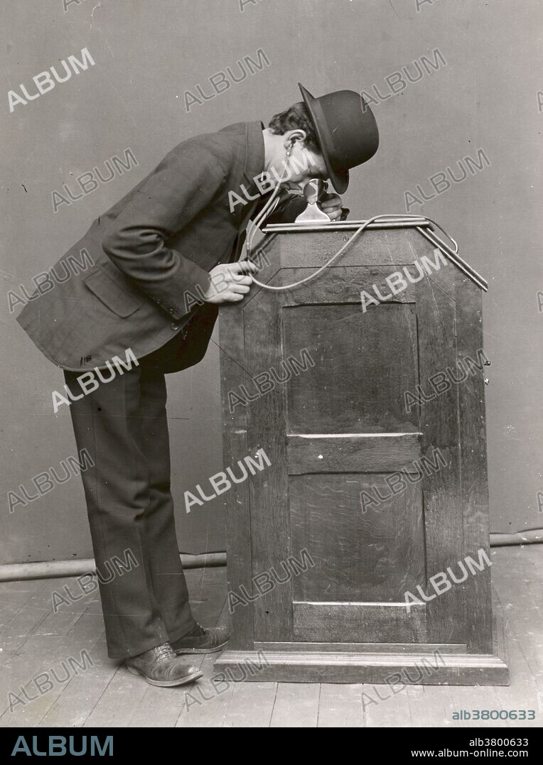 The 1895 version of the Kinetophone in use, showing the earphones that lead to the cylinder phonograph within the cabinet. The Kinetophone (aka Phonokinetoscope) was an early attempt by Edison and Dickson to create a sound-film system. Reports suggest that in July 1893, a Kinetoscope accompanied by a cylinder phonograph had been presented at the Chicago World's Fair. The first known movie made as a test of the Kinetophone was shot at Edison's New Jersey studio in late 1894 or early 1895, which is now referred to as the Dickson Experimental Sound Film; this film, along with a short film from 1913 called Nursery Favorites and a 1912 demonstration film, are the only surviving movies with live-recorded sound made for the Kinetophone.