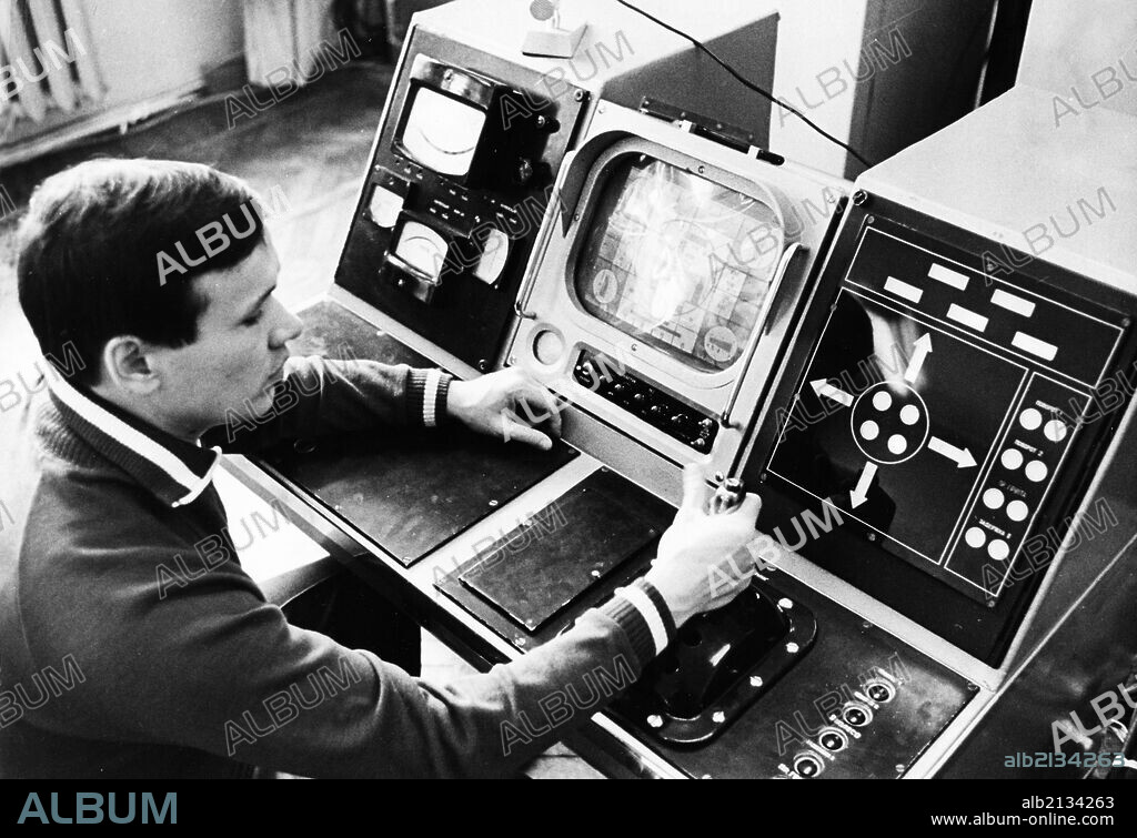 Luna 21 mission, an operator preparing the equipment for communication traffic, working at the controls of the soviet remote-controlled lunar rover, lunokhod 2 at the distant space communications center, january 1973.
