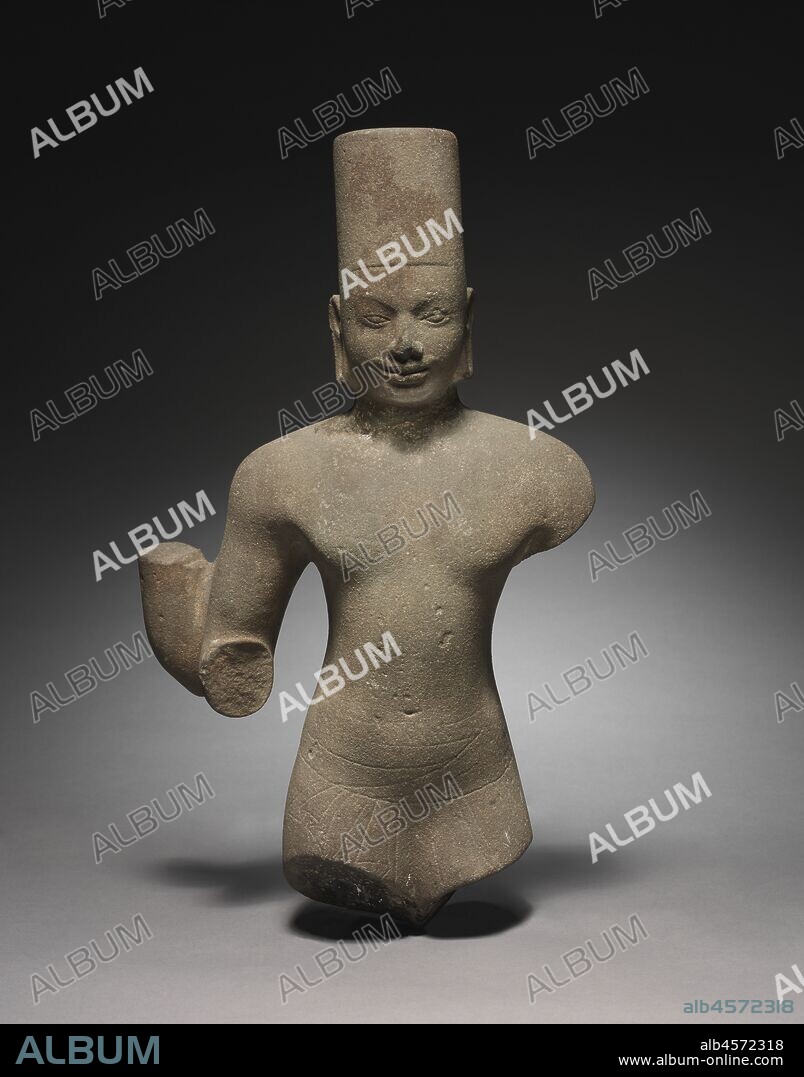 Vishnu, 650-700. Vishnu has the features of royalty, indicated by the high mitre-like crown with the flat top, distinctive to types made at the site of Prasat Andet. His status as a god, greater than any earthly king, is indicated by the four arms, traces of which are still visible. The sensitive rendering of the eyes and slight smile are characteristics of Cambodian sculpture, and during this early period, the form of the body reveals some relatively naturalistic musculature and treatment of the garments. He wears the Southeast Asian lower garment called sampot, around which his upper garment is loosely tied.It is Vishnu who incarnates himself into the world in avatars, including Krishna and the boar Varaha.Here we see his iconic form as Vishnu himself.