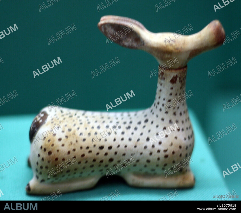 Pottery bottle shaped as a female deer for perfume. The head is the stopper and is removable. Greek made in Italy. Etruscan circa 600-550 BC.