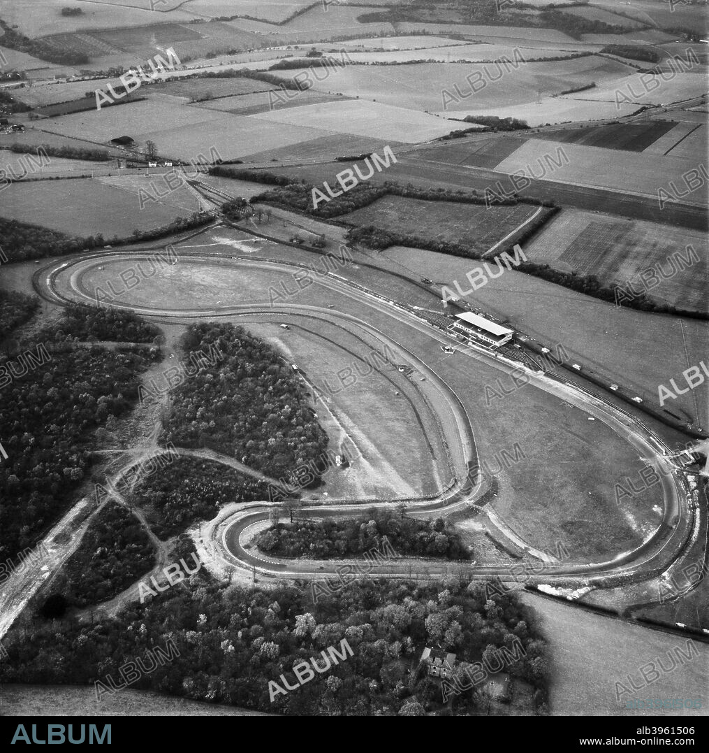 Brands Hatch motor racing circuit, West Kingsdown, Kent, 1955. Photographed five years after the introduction of the first tarmac surface. In the foreground are Druids with Paddock Hill to the right, and the newly installed Grandstand on the pit straight. This original circuit remains as the Indy circuit. The Grand Prix extension was built in 1960.