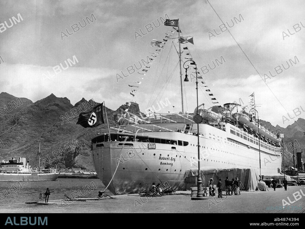 SPAIN SANTA CRUZ DE TENERIFE 1939-04-30. Orig. caption ... "ROBERT LEY" ON THE GOAL OF YOUNG JUNGFERNFRART IN TENERIFFA. The KdF fleet's flagship "Robert Ley" reached on 26 April the destination of its maiden voyage, Santa Cruz, the capital of Tenerife, which belongs to the Canary Islands. Our recording shows the proud ship in the bay of Santa Cruz. Photo: Scherl Bilderdienst / AB Text & Bilder / SVT / Code: 5600 Folder: "Kraft durch Freude" 91A KDF organized trips for German workers on the cruise ships Wilhelm Gustloff and Robert Ley. Passenger ships Canary Islands Swastikas sites: GERMANY *; SANTA CRUZ DE TENERIFE; TENERIFFA; SPAIN.