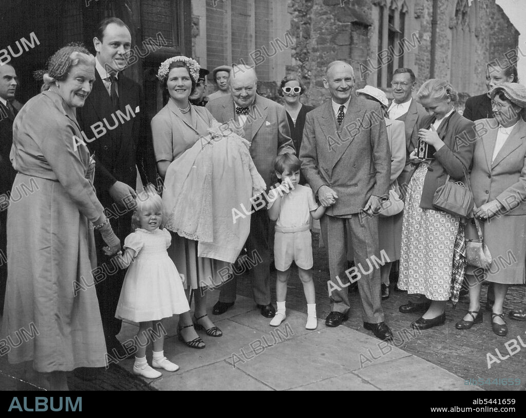 A Churchill Grandchild Is christened -- British Premier Winston Churchill beams happily with his family after the christening of his eighth grandchild, Jeremy Soames, at Westerham, Kent church to-day (Sunday). Holding the baby is the mother Mrs. Christopher Soames (formerly Mary Churchill, daughter of the Premier). A godfather, Field Marshal Viscount Montgomery clasps the hand of the baby's brother, Nicholas. At left is Mrs. Clementine Churchill, wife of the Premier, holding the baby's sister, Emma, with Captain Christopher Soames. August 17, 1952. (Photo by Reuterphoto).