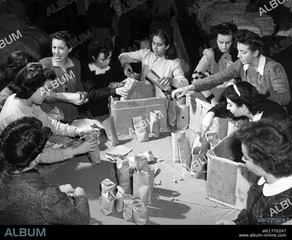 Christmas presents for soldiers. In the headquarters of the UDI (Union of Italian Women) some girls packing Christmas presents for soldiers fighting by the side of the Allies. Rome, December 1944.