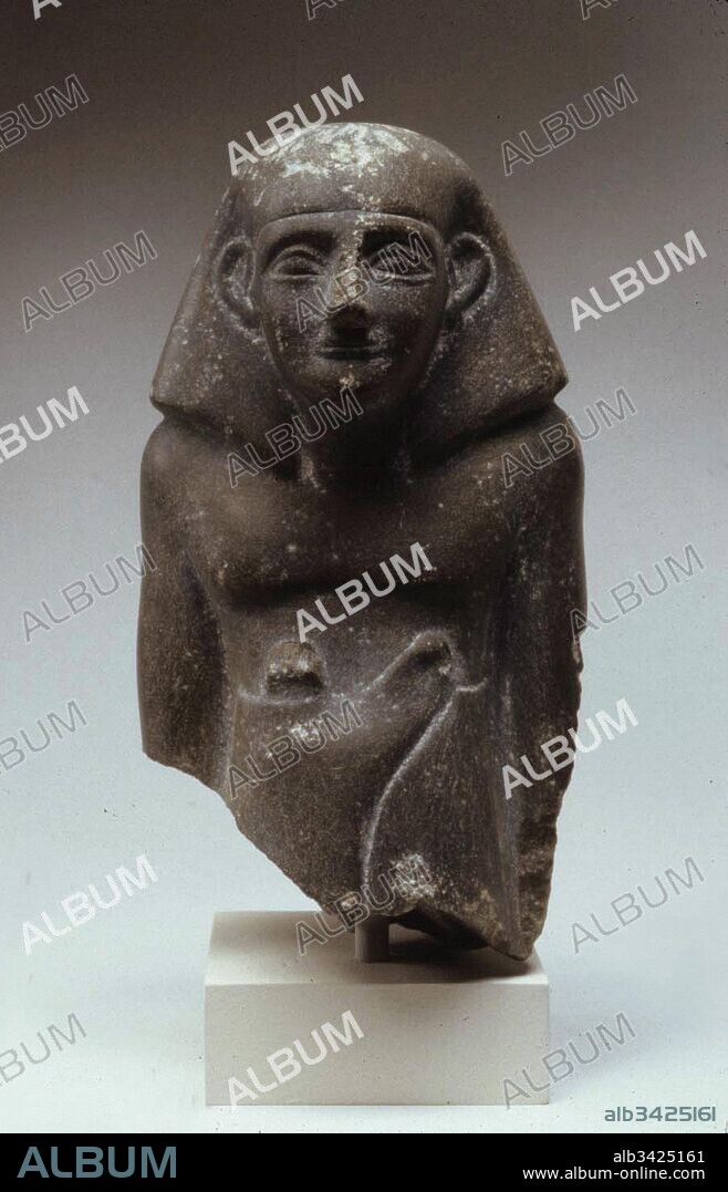 Statuette of Senbi in long kilt, Middle Kingdom, Dynasty 12–13, ca. 1802–1640 B.C., From Egypt, Memphite Region, Lisht North, cemetery south of pyramid south of House A1:4, Pit 898, 1920–21, Schist, H.13.9 × W.7.7 × D.7.5 cm (5 1/2 × 3 1/16 × 2 15/16 in.).