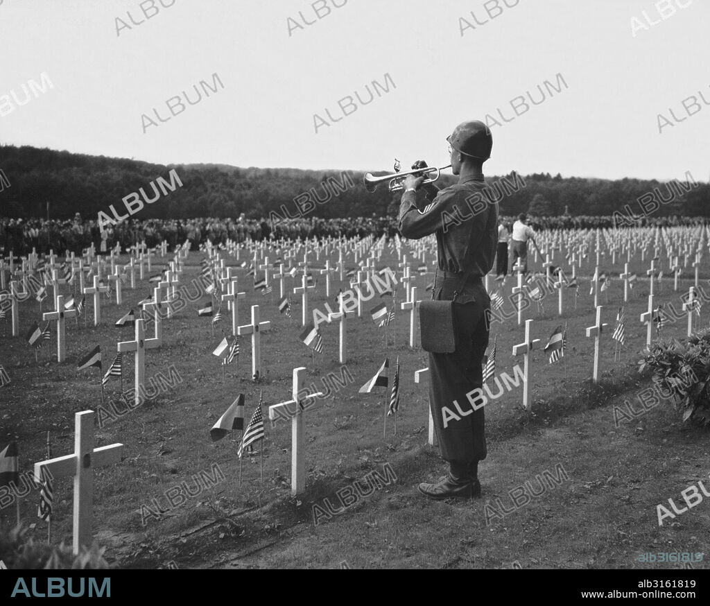 Hamm, Luxembourg: May 30, 1946. A U.S. soldier plays taps at the Luxembourg American Cemetery in a Memorial Day service honoring the American soldiers who gave their lives in World War II.