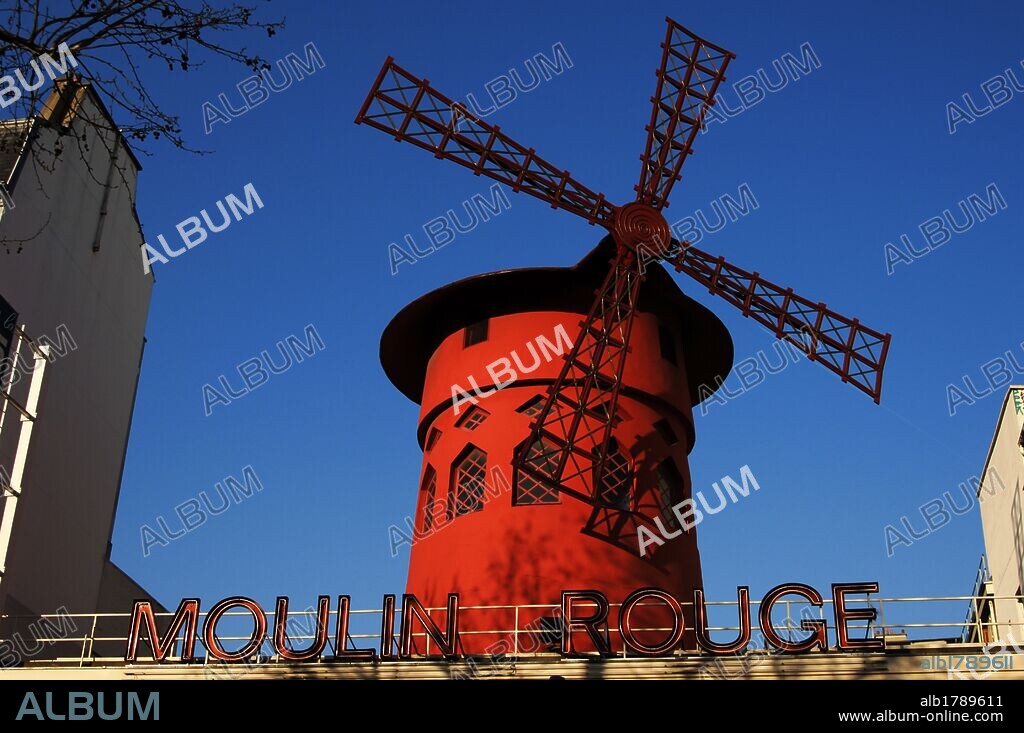 France. Paris. Moulin Rouge. Cabaret, opened in 1889. Built by Adolphe Leon Willette (1857-1926) and Edouard-Jean Niermans (1859-1928). Marked by the red windmill on its roof. Detail. Exterior. Pigalle district.