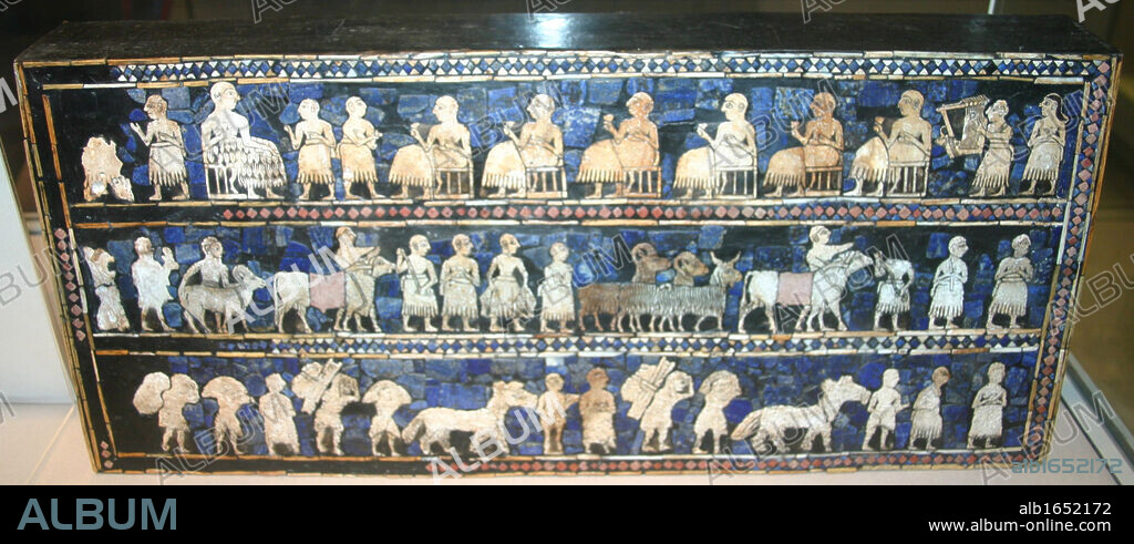 The Standard of Ur, Sumerian artefact excavated from what had been the Royal Cemetery in the ancient city of Ur, dates from around 2600 - 2400 BC. Excavated by British archaeologist Sir Leonard Woolley in the 1920s. A hollow wooden box measuring 21.59 x 49.53 cm, inlaid with a mosaic of shell, red limestone and lapis lazuli. It is currently in a reconstructed state. The Standard of Ur has two main panels, 'War' and 'Peace'. Here in 'Peace' a banquet is represented. Attendants parade animals, fish, and other goods (possibly war booty) before seated figures, while a lyre player entertains the throng.