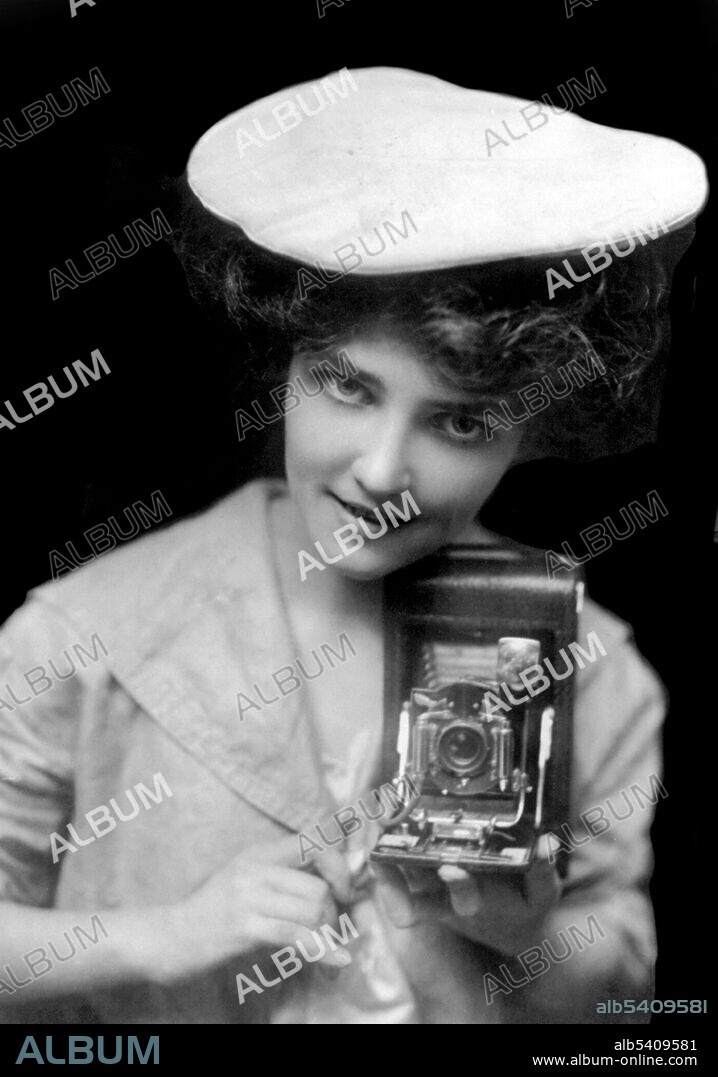 Editorial use only . No. 28, The Kodak Girl. Kodak was founded by George Eastman and Henry A. Strong on September 4, 1888. During most of the 20th century, Kodak held a dominant position in photographic film. The company's ubiquity was such that its Kodak moment tagline entered the common lexicon to describe a personal event that was demanded to be recorded for posterity. An amateur photographer may take photographs for pleasure and to record an event, emotion, place, as a person without a monetary motivation. An amateur may make considerable sums entering work in contests for prize money or through occasional inclusion of their work in magazines or the archive of a photo agency. No photographer credited, 1909.