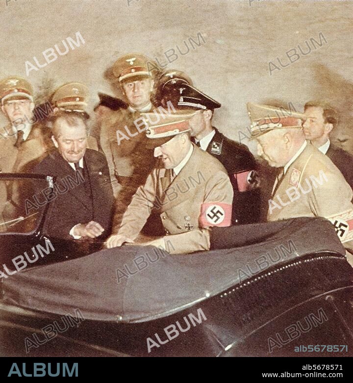 Porsche, Ferdinand Autokonstrukteur (Rennwagen bei Daimler, 1934 Konstrukteur des Volkswagens; ab 1931 eigenes Konstruktionsbüro in Stuttgart); 1875-1951. - Adolf Hitler erhält zum Geburtstag einen Volkswagen; in Zivil Ferdinand Porsche; rechts der Führer der Arbeitsfront, Robert Ley. Foto, 1939 (?).