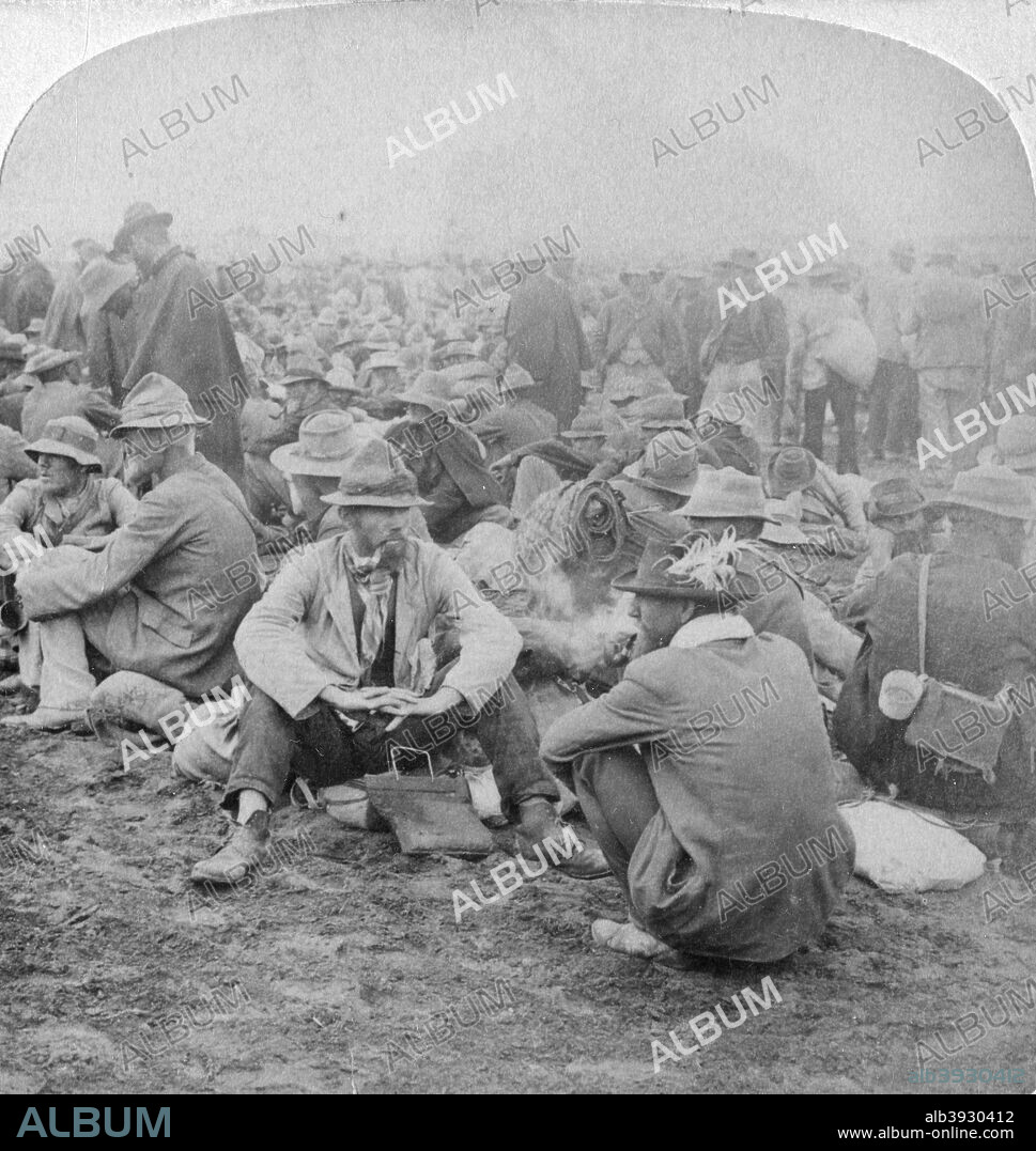 Boer prisoners of war, South Africa, 2nd Boer War, 1900. 'Cronje's men at Modder River waiting to be assigned to tents in the British prison camp'. The Boer general  Piet Cronje (1835-1911) surrendered to Lord Roberts, the British commander-in-chief in South Africa, after the Battle of Paardeberg (18-27 February 1900). Stereoscopic card. Detail.