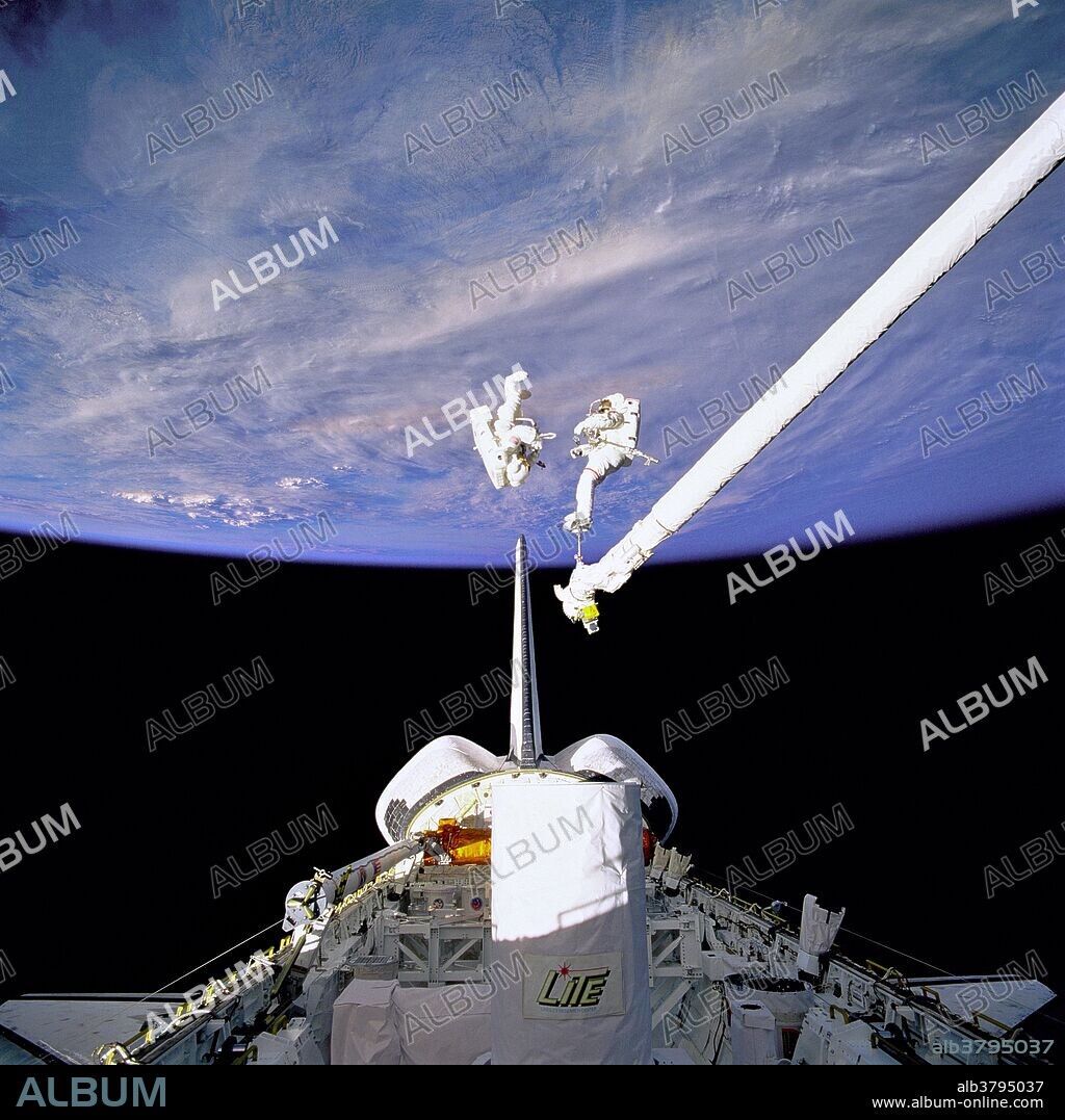 Astronauts Carl J. Meade and Mark C. Lee (red stripe on suit) test the Simplified Aid for EVA Rescue (SAFER) system some 130 nautical miles from Earth. The pair were actually performing an in-space rehearsal or demonstration of a contingency rescue using the never- before flown hardware. Meade, who here wears the small back-pack unit with its complementary chest-mounted control unit, and Lee, anchored to Discovery's Remote Manipulator System (RMS) robot arm, took turns using the SAFER hardware during their shared space walk of September 16, 1994.