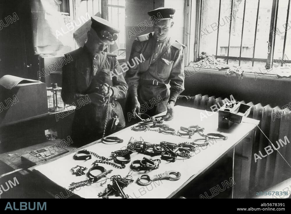 World War Two / End of the War / Berlin under Soviet military administration. Soviet NKVD soldiers examine some handcuffs at the former Gestapo HQ in Prinz Albrecht Strasse. Photo (Y.Khaldei), around May 1945.