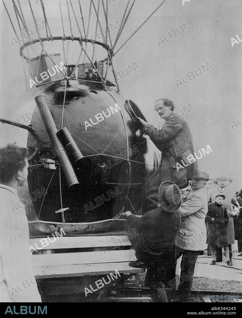 10 Miles Up In A Balloon -- Prof. Auguste Piccard climbing into the aluminium globe attached to the balloon.In a hermetically sealed cylinder hanging from a giant balloon, a Swiss scientist today began an attempt to go higher in the air than man has ever gone before. He is Prof. Auguste Piccard, member of the staff of Brussels University, and he hopes to reach a height of ten miles above the earth. He is accompanied by an assistant. The start was made soon after dawn from a field at Augsburg, Bavaria. May 27, 1931. (Photo by Topical Press).