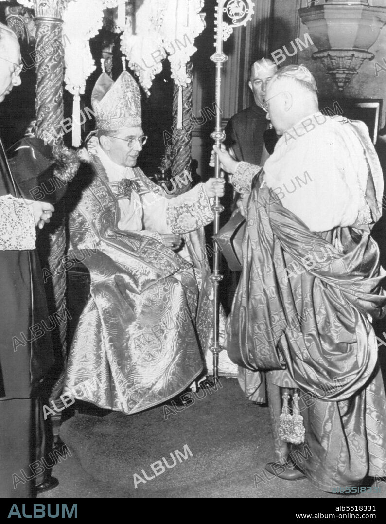 New New Archbishop Installed -- Archbishop J. Francis A. McIntyre, seated on the Episcopal throne, receives the crosier, symbol of his office, from the hands of Francis Cardinal Spellman of New York at his installation today as Archbishop of Los Angles. March 19, 1948. (Photo by AP Wirephoto).