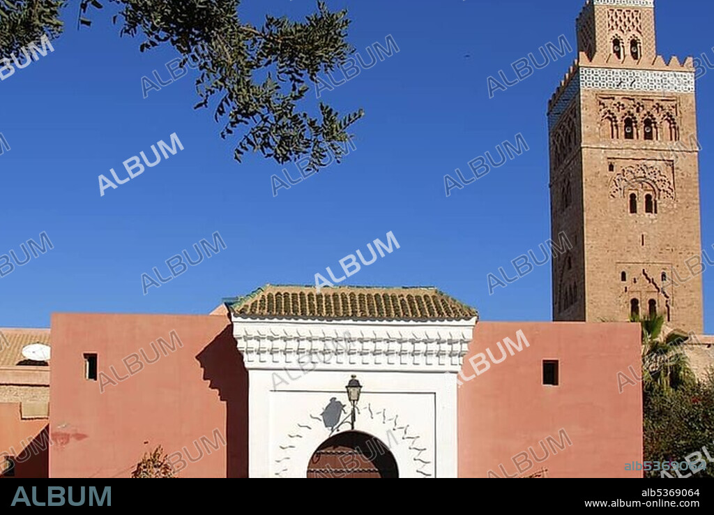 Old minaret and entrance gate Koutoubia mosque Marrakech Morocco.
