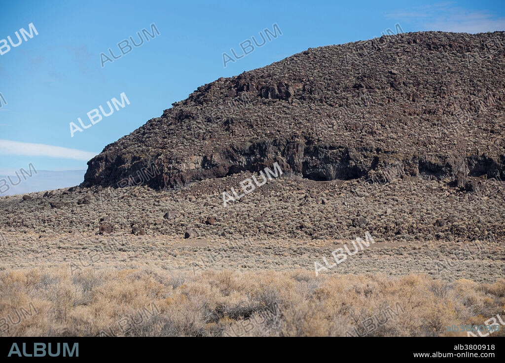Paisley Caves is widely regarded as the oldest confirmed archaeological site in the western hemisphere at 14,500 years old. The caves are located in a volcanic formation called Five Mile Point in central Oregon. When the site was occupied the plain in the foreground would have been a vast lake.