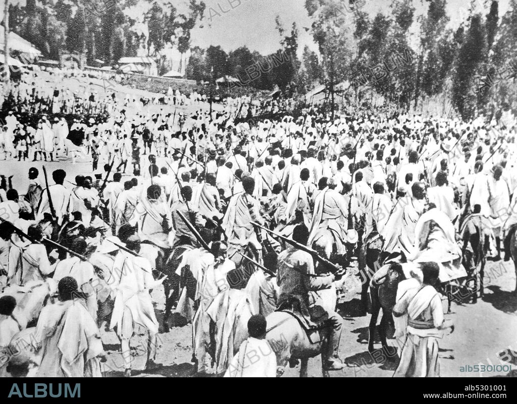 Black and white photo of the War in Ethiopia after the Italian invasion of 1935; Ethiopian soldiers march in front of the Negus (emperor) in Addis Adiba.